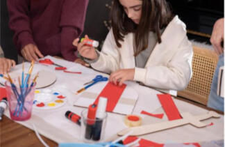 Parent and child building a craft house